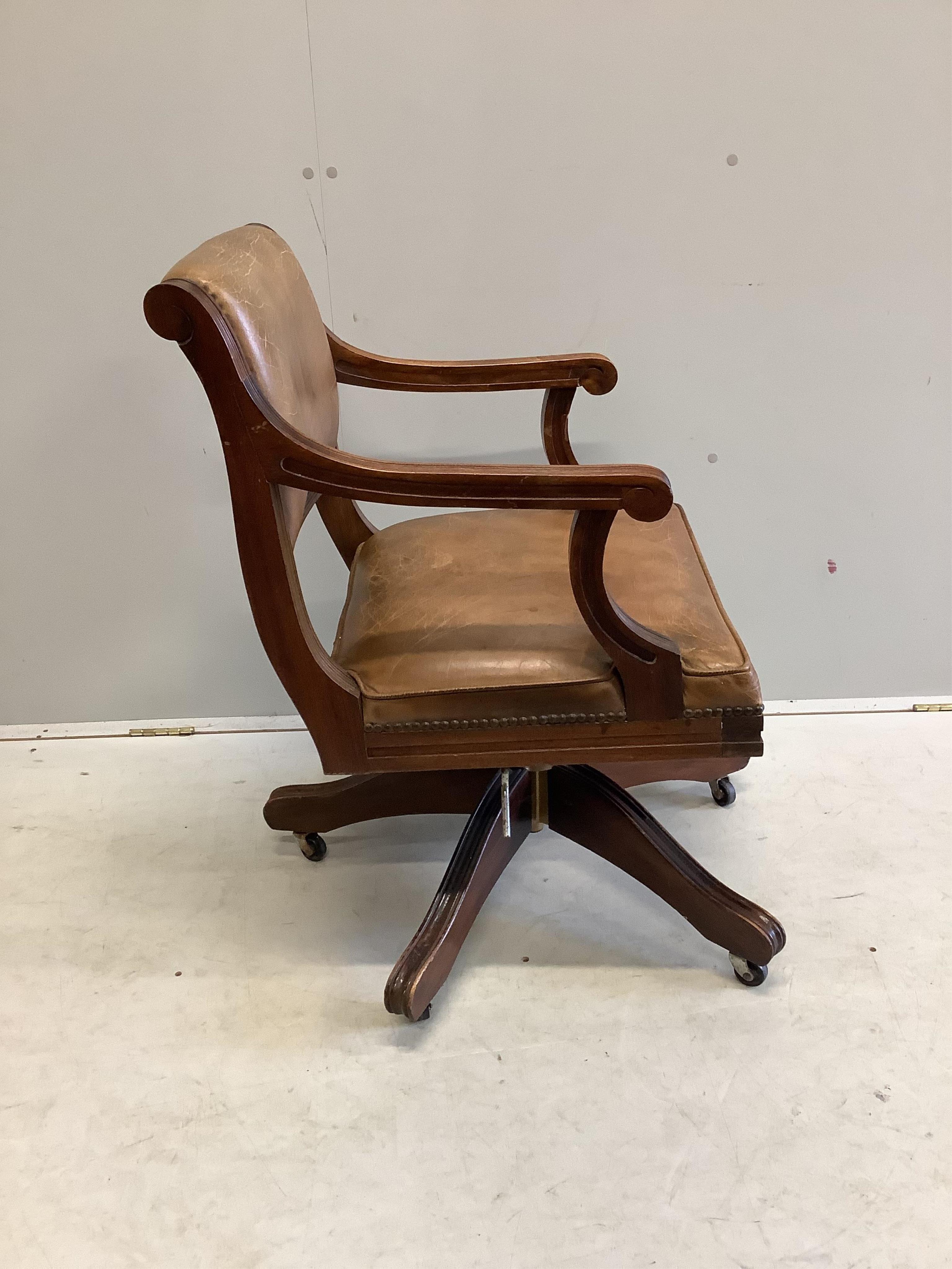 A reproduction mahogany and tan leather swivel desk chair, width 56cm, depth 52cm, height 84cm. Condition - fair